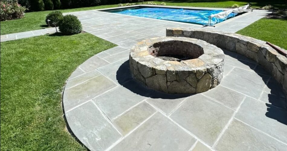 Bluestone Patio & Fire Pit for a Seamless Poolside Retreat