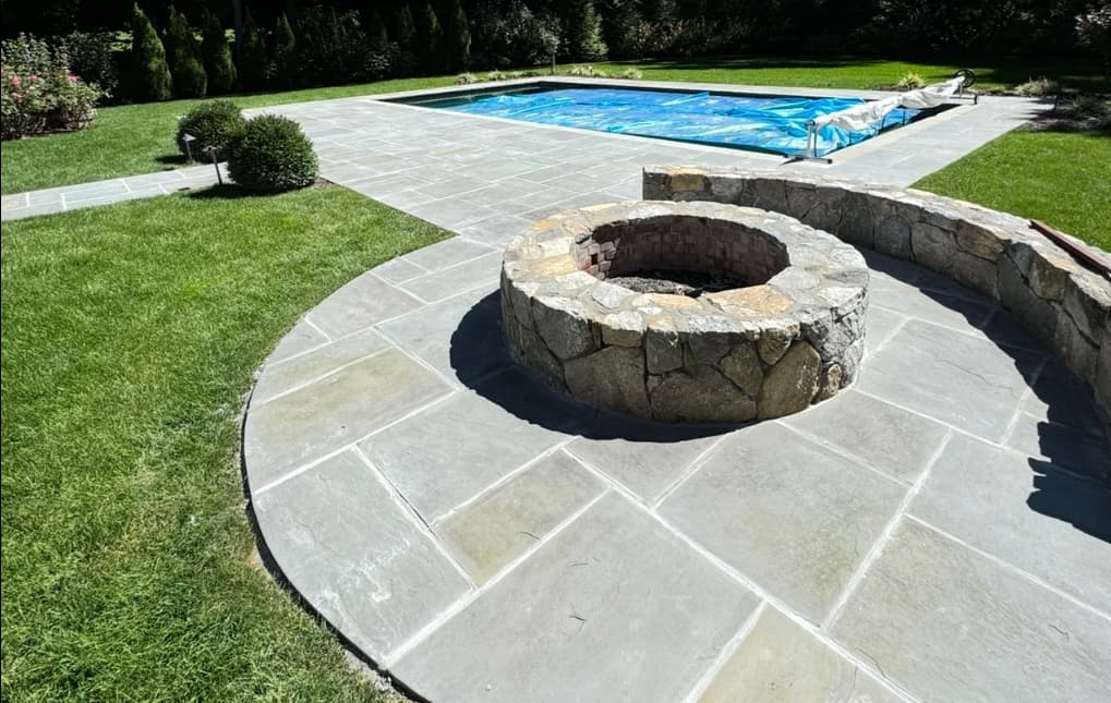 Bluestone Patio & Fire Pit for a Seamless Poolside Retreat